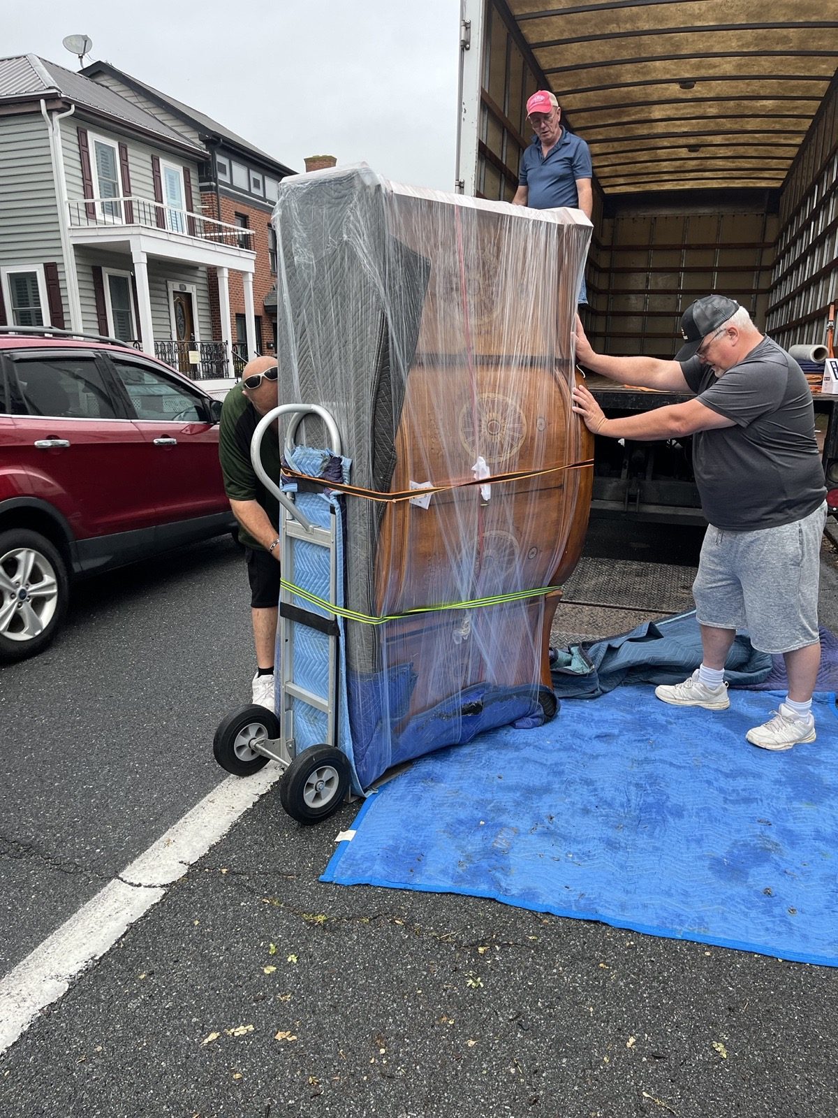 Roger That team preparing wrapped furniture during a home transition